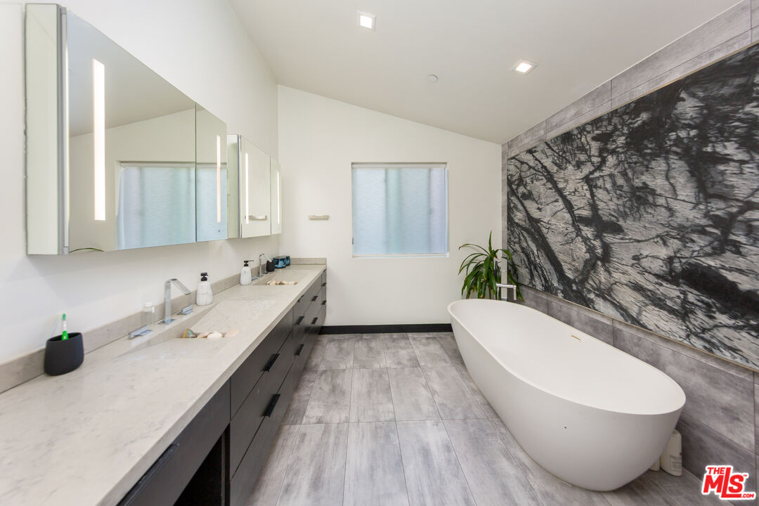 9401 Kirkside Road Los Angeles, CA 90035 - Photo 9 of 18 a bathroom with a sink and a mirror
