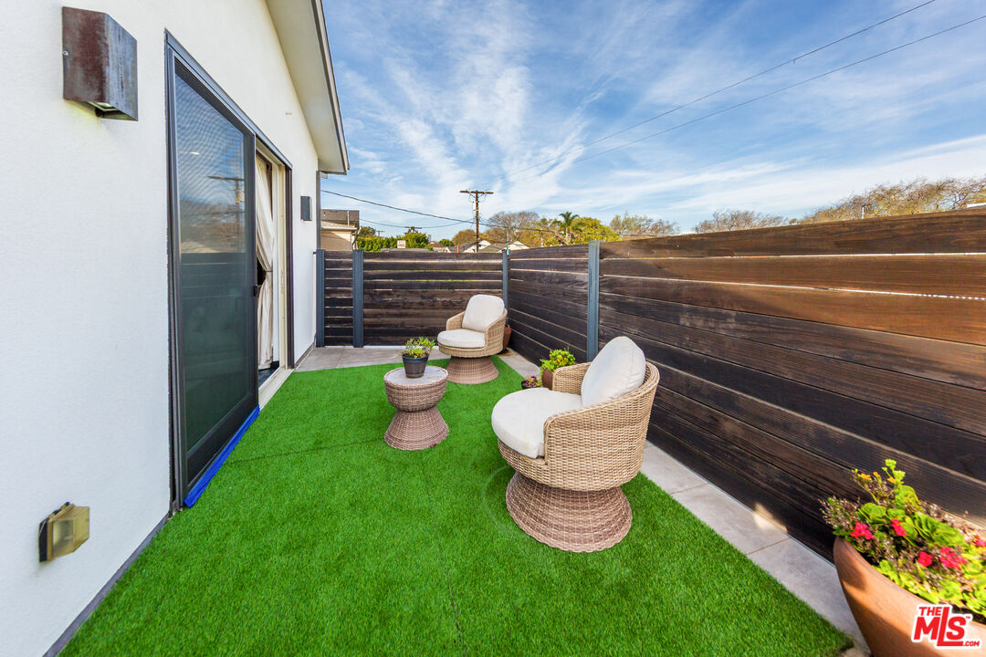 9401 Kirkside Road Los Angeles, CA 90035 - Photo 10 of 18 a view of a chairs and table in patio with a yard