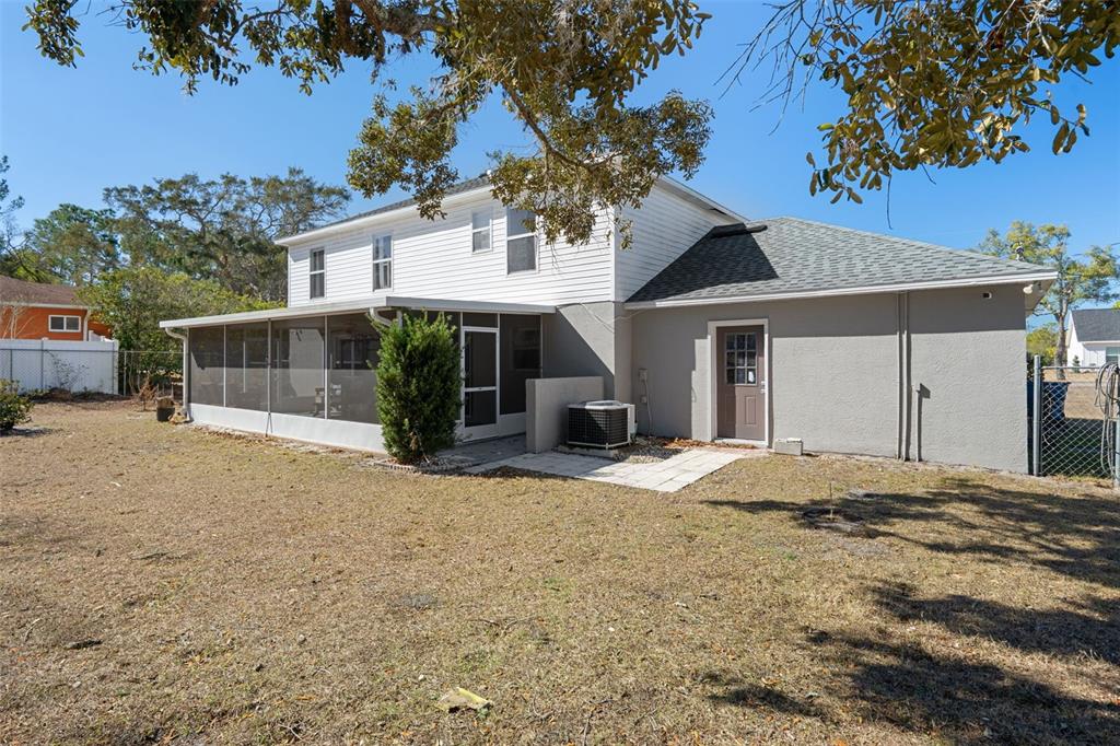 11258 Lomita Wren Road Weeki Wachee, FL 34614 - Photo 41 of 44 a front view of a house with a yard and garage