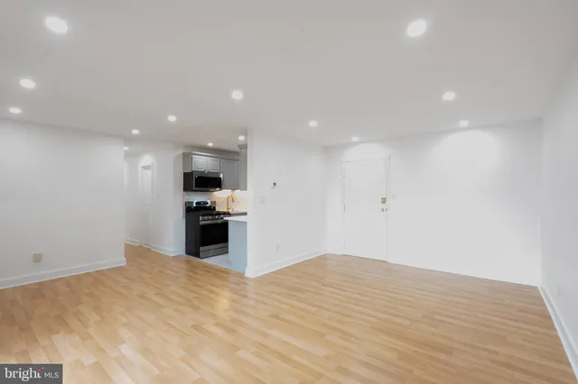 a view of kitchen with kitchen island sink and refrigerator