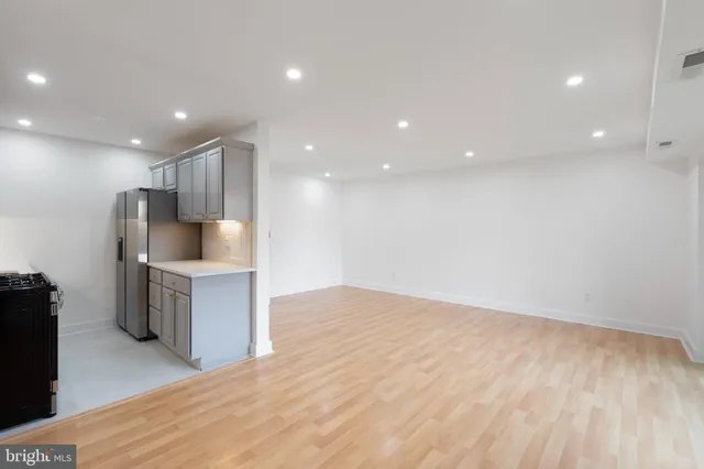 a view of kitchen with refrigerator sink and cabinets