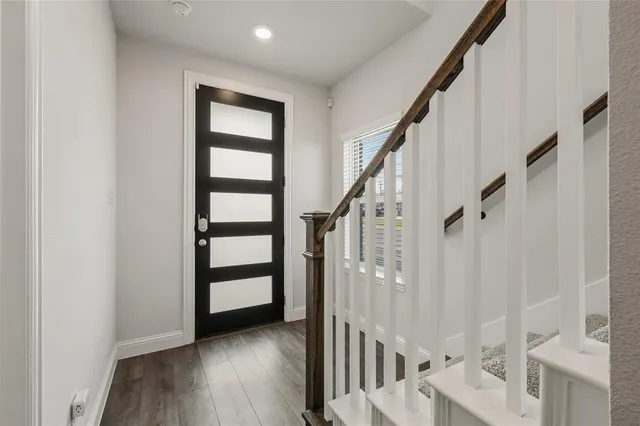 a view of an entryway with wooden floor and door
