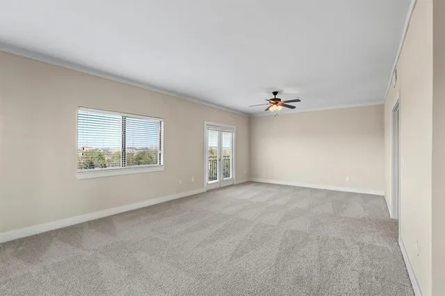 an empty room with windows and cabinet