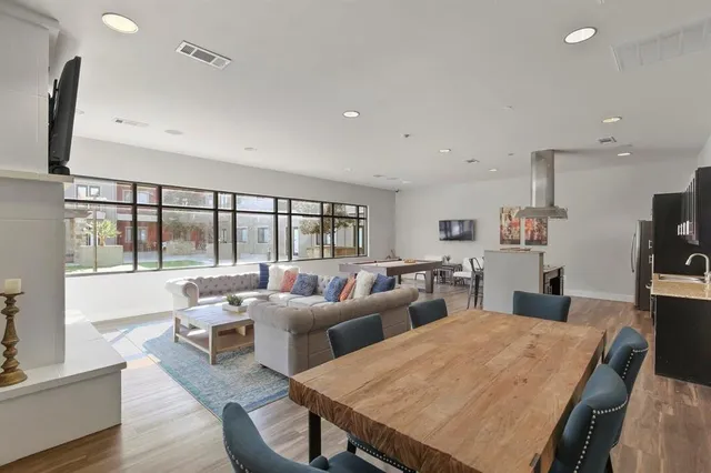 a living room with furniture a large window and a flat screen tv