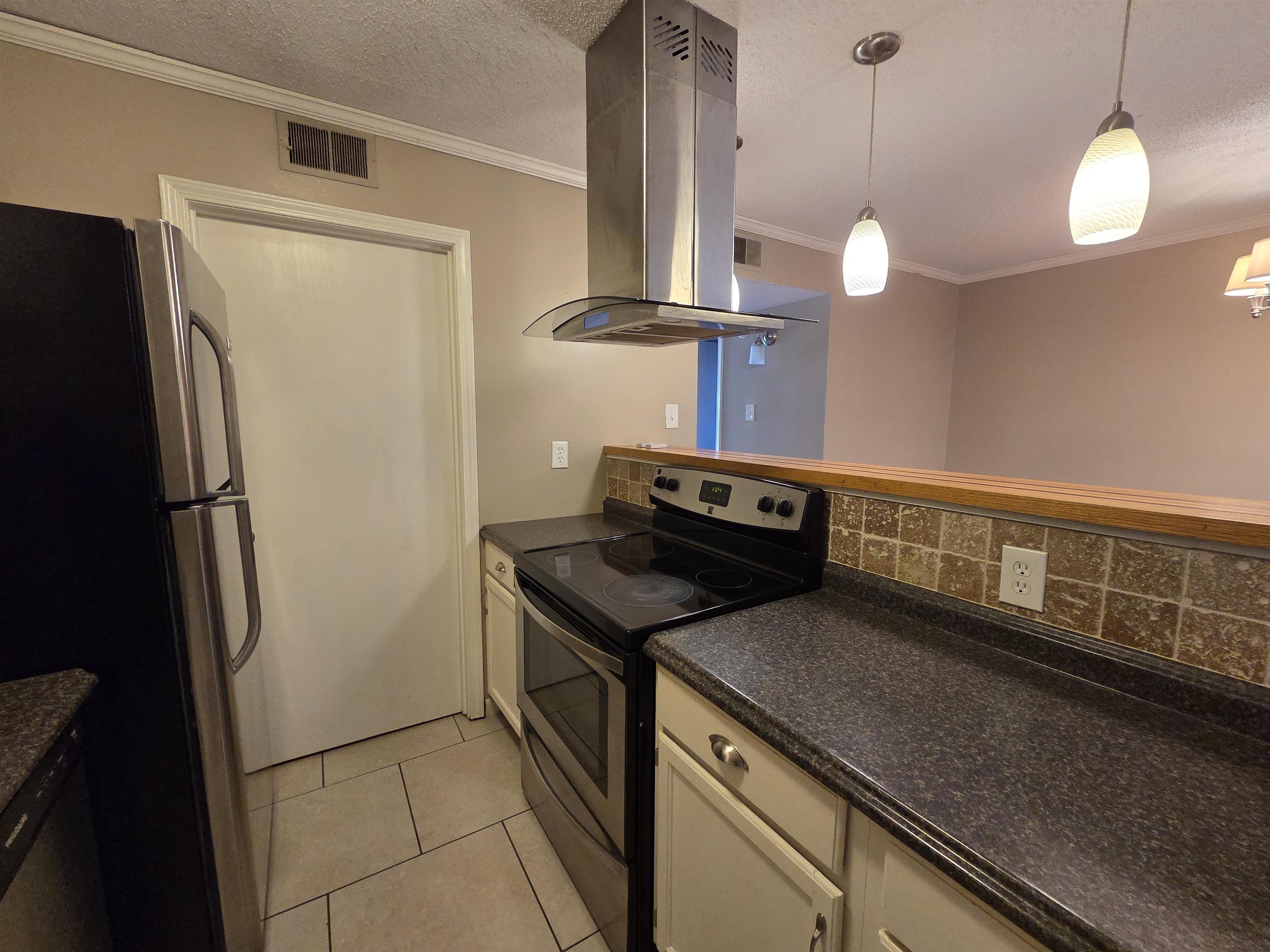 2104 Harbert Avenue Memphis, TN 38104 - Photo 18 of 26 a kitchen with a refrigerator and a wooden floor
