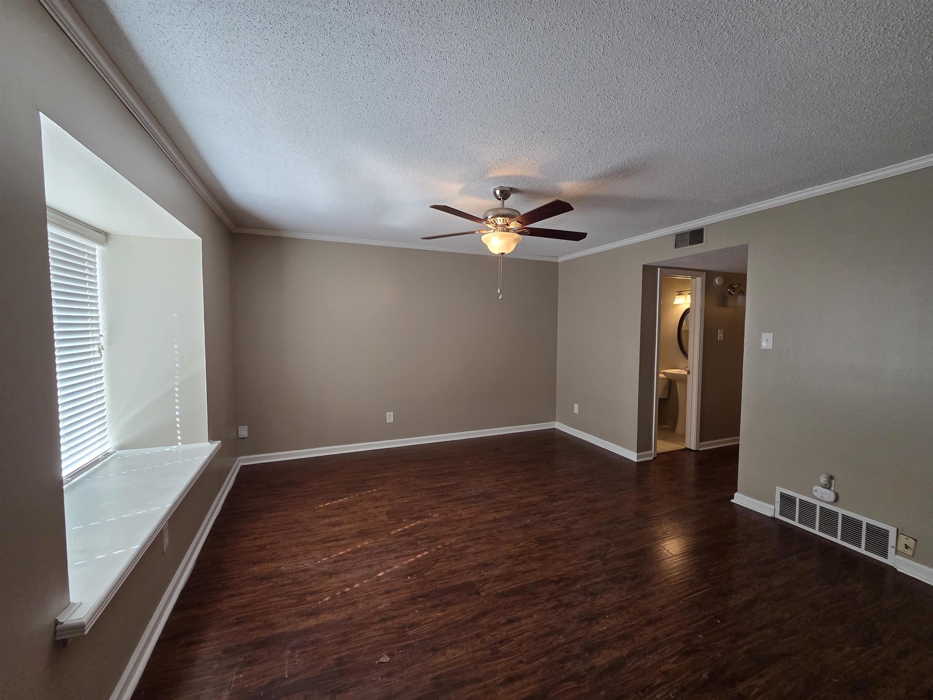 2104 Harbert Avenue Memphis, TN 38104 - Photo 2 of 26 a view of an empty room with wooden floor and a window