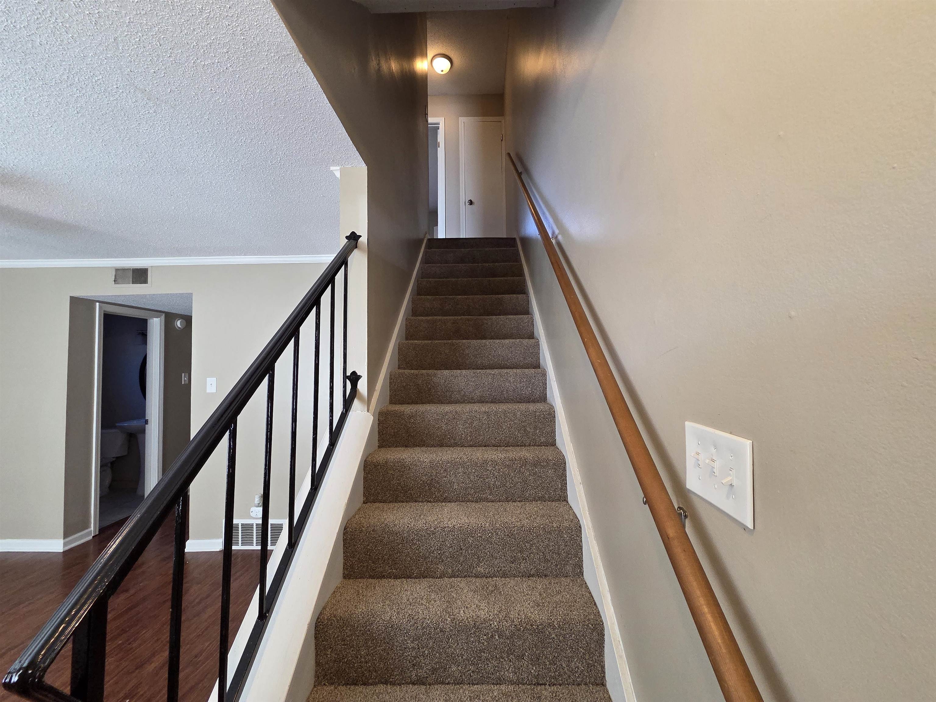 2104 Harbert Avenue Memphis, TN 38104 - Photo 7 of 26 Stairway featuring a textured ceiling, wood finished floors, and ornamental molding