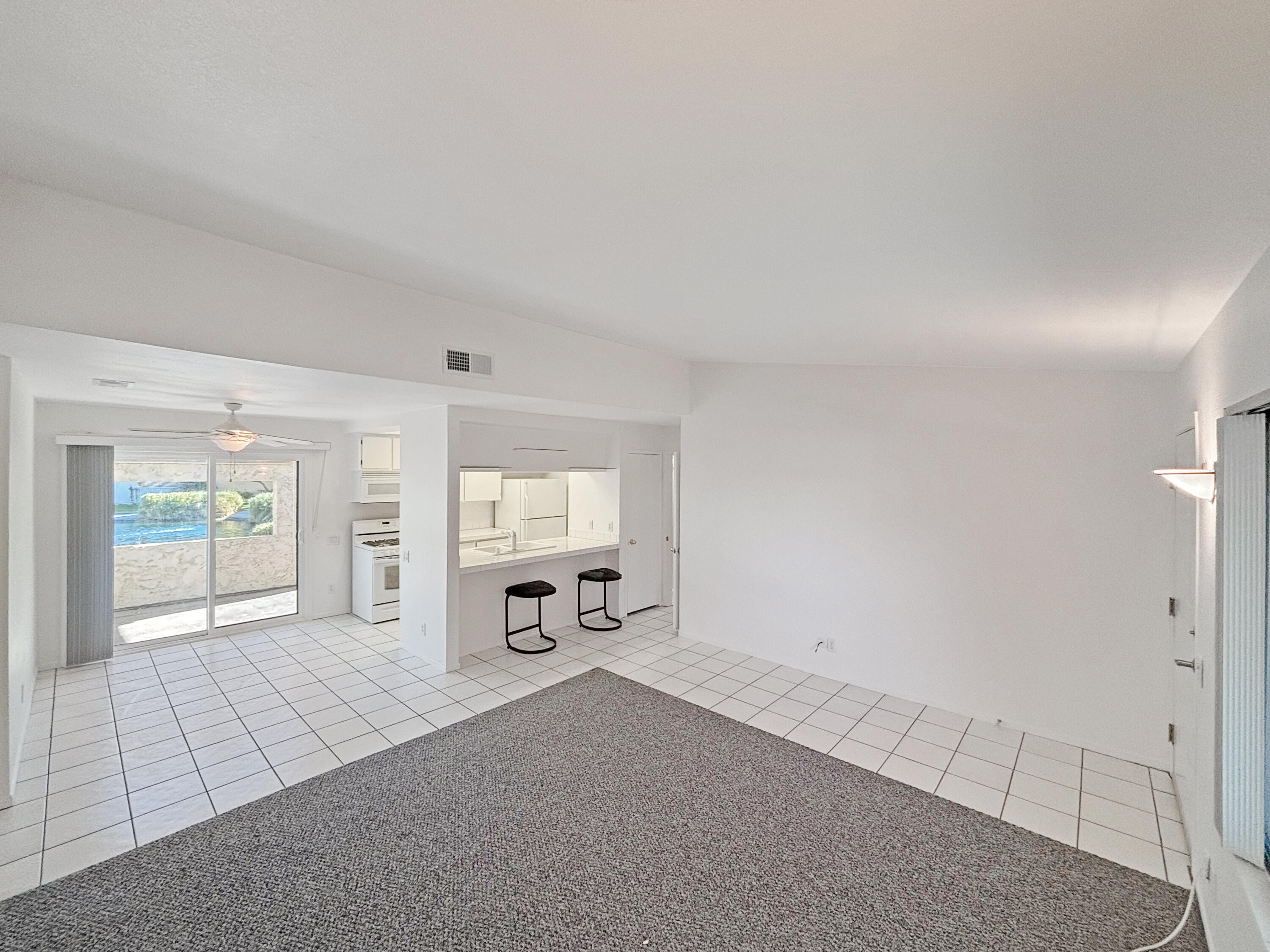 63 Lakeview Circle Cathedral City, CA 92234 - Photo 4 of 15 an empty room with windows and fireplace