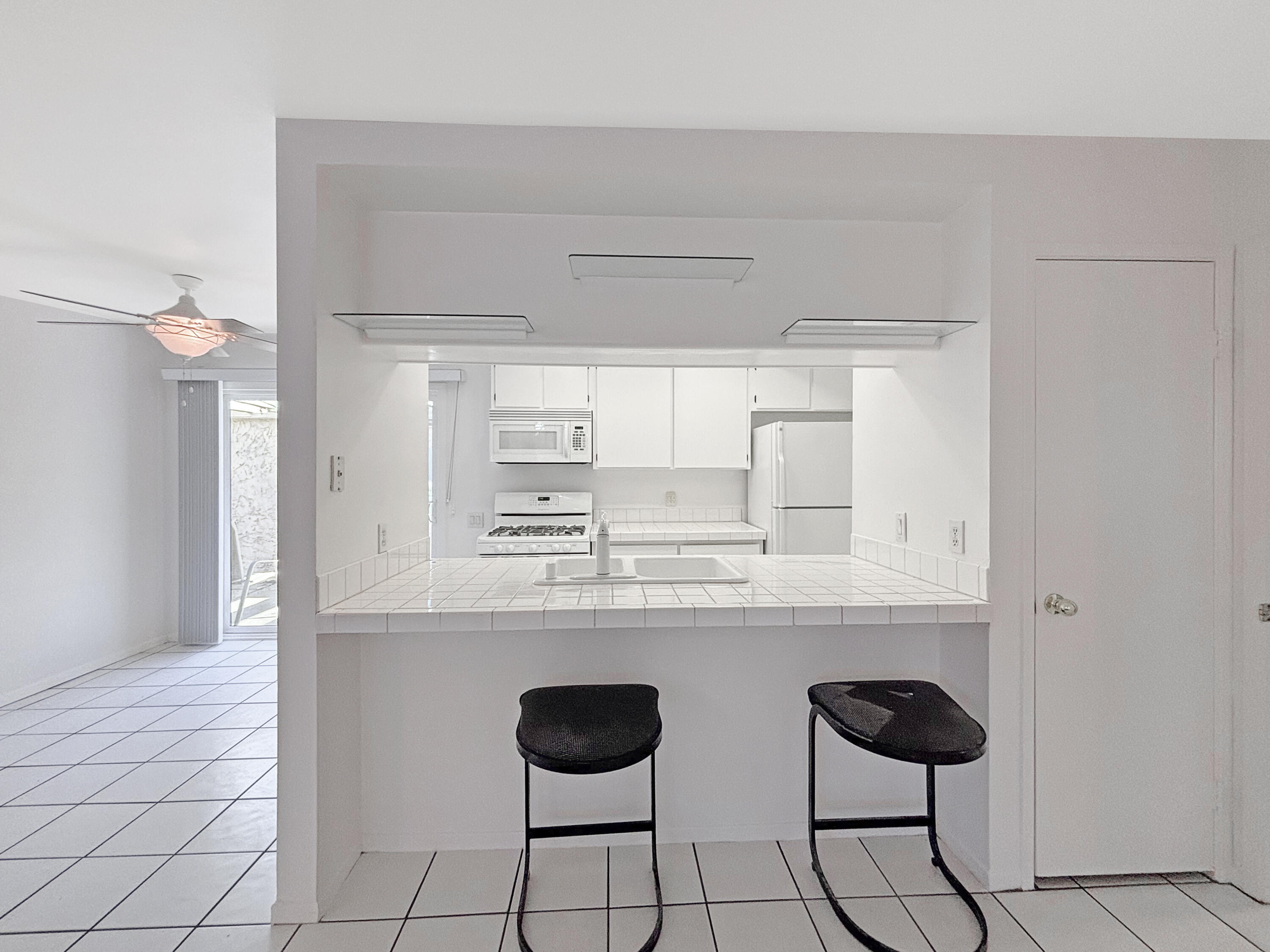 63 Lakeview Circle Cathedral City, CA 92234 - Photo 6 of 15 a kitchen with cabinets and chairs