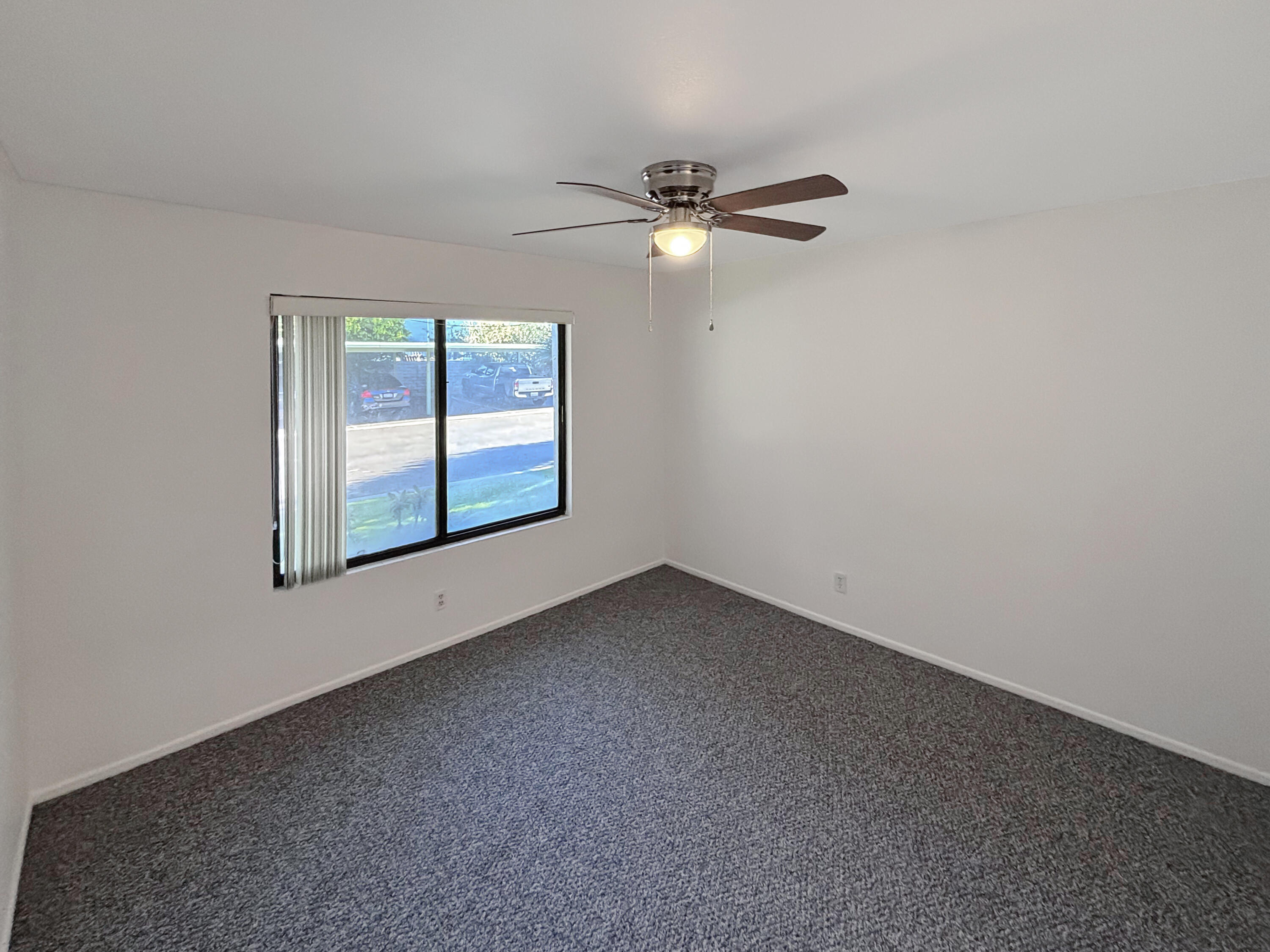 63 Lakeview Circle Cathedral City, CA 92234 - Photo 10 of 15 an empty room with windows and fan