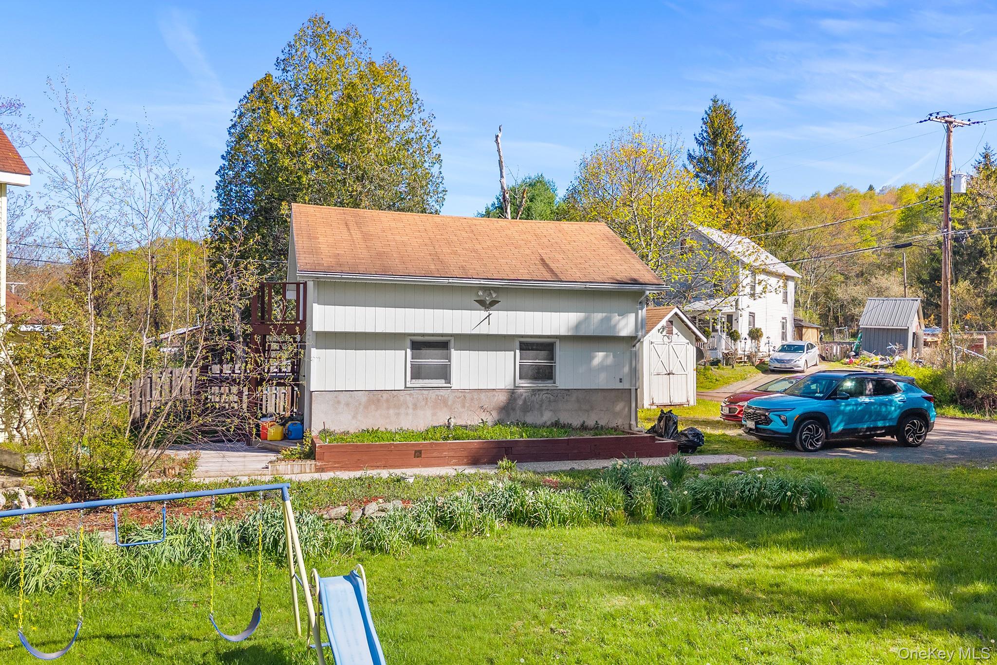 43 Taylor Road Parksville, NY 12768 - Photo 5 of 29 a front view of a house with a yard table and chairs