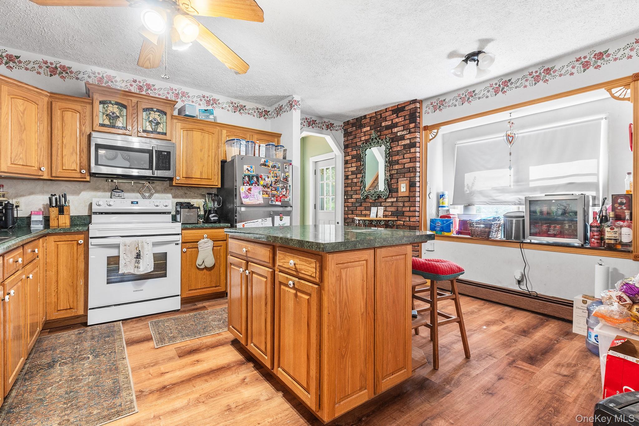 43 Taylor Road Parksville, NY 12768 - Photo 8 of 29 a kitchen with stainless steel appliances granite countertop a stove a sink and a refrigerator
