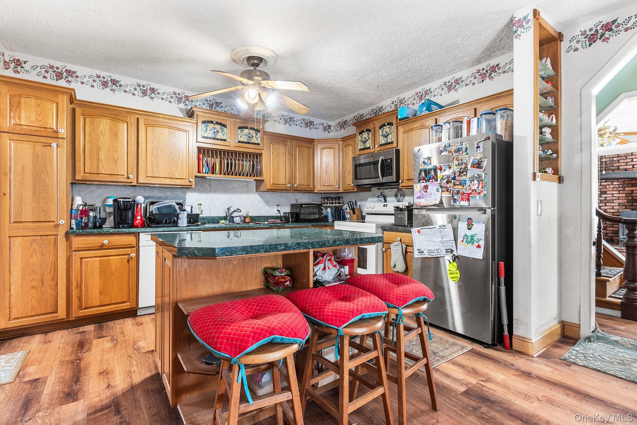 43 Taylor Road Parksville, NY 12768 - Photo 9 of 29 a kitchen with stainless steel appliances granite countertop a dining table chairs sink and cabinets