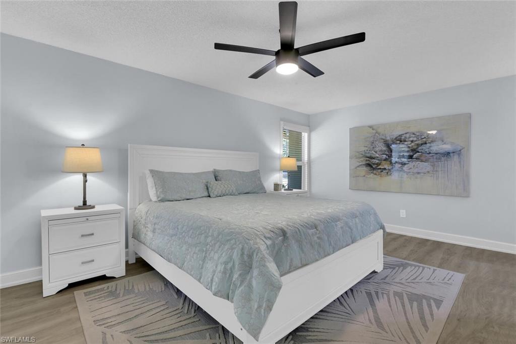 150 1st Avenue North Naples, FL 34102 - Photo 16 of 44 a bedroom with a bed and a chandelier