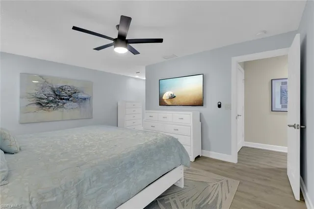 a bedroom with a bed and a painting on the wall