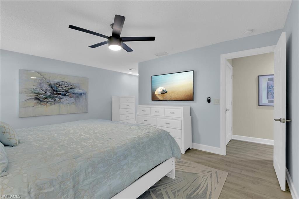150 1st Avenue North Naples, FL 34102 - Photo 18 of 44 a bedroom with a bed and a painting on the wall