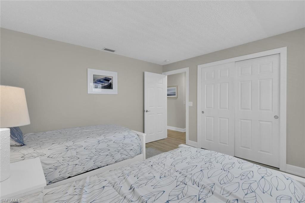 150 1st Avenue North Naples, FL 34102 - Photo 22 of 44 a view of a bedroom with a bed and hallway