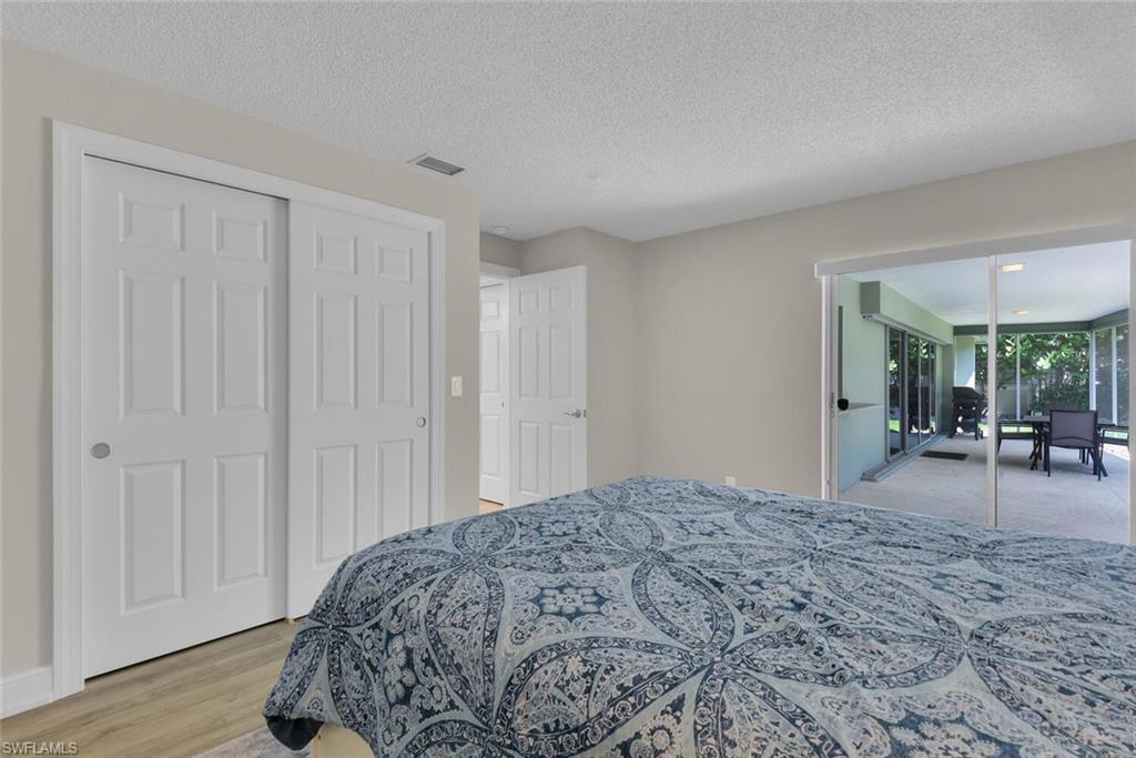 150 1st Avenue North Naples, FL 34102 - Photo 25 of 44 a bedroom with a bed and a large window