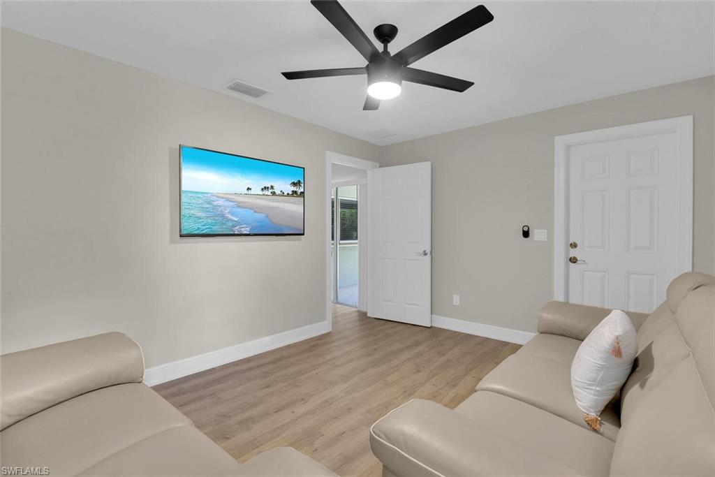 150 1st Avenue North Naples, FL 34102 - Photo 29 of 44 a living room with furniture and a ceiling fan