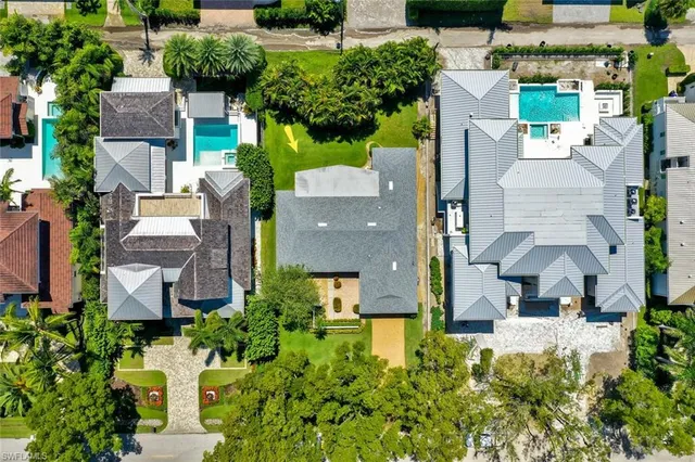 an aerial view of a house with a garden and yard