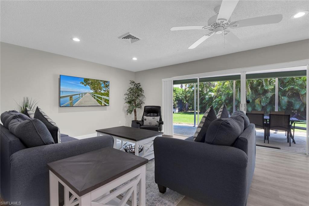150 1st Avenue North Naples, FL 34102 - Photo 6 of 44 a living room with furniture and a large window
