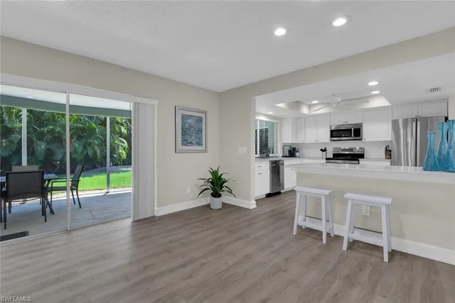 a view of kitchen with furniture and wooden floor
