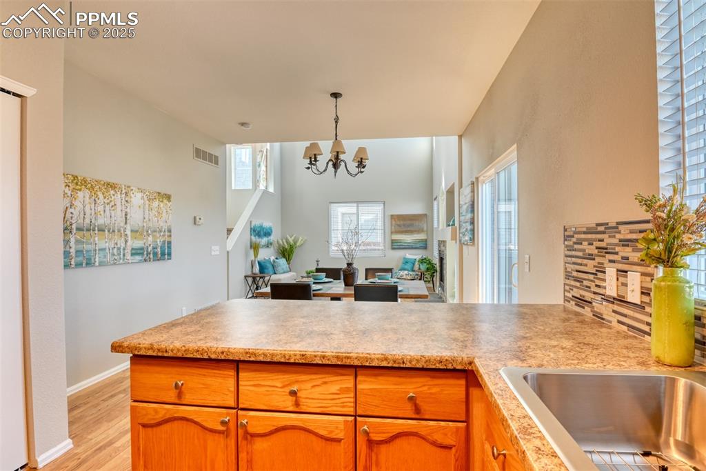 6810 Shore View Colorado Springs, CO 80922 - Photo 16 of 48 a view of a kitchen with kitchen island a counter top space and a sink