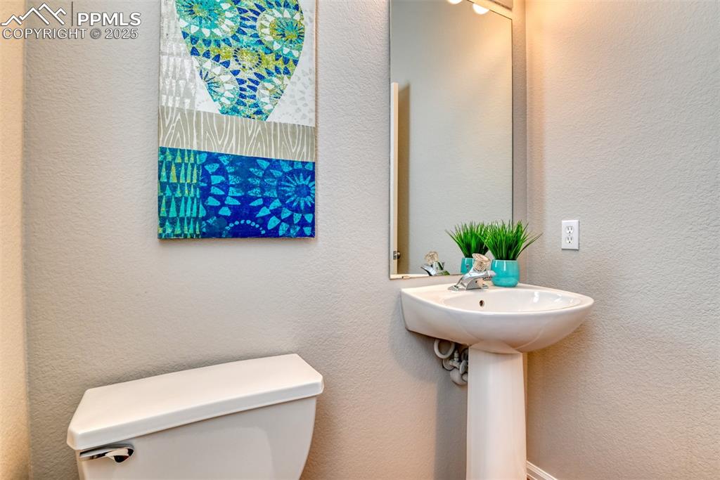 6810 Shore View Colorado Springs, CO 80922 - Photo 19 of 48 a bathroom with a sink toilet and a mirror