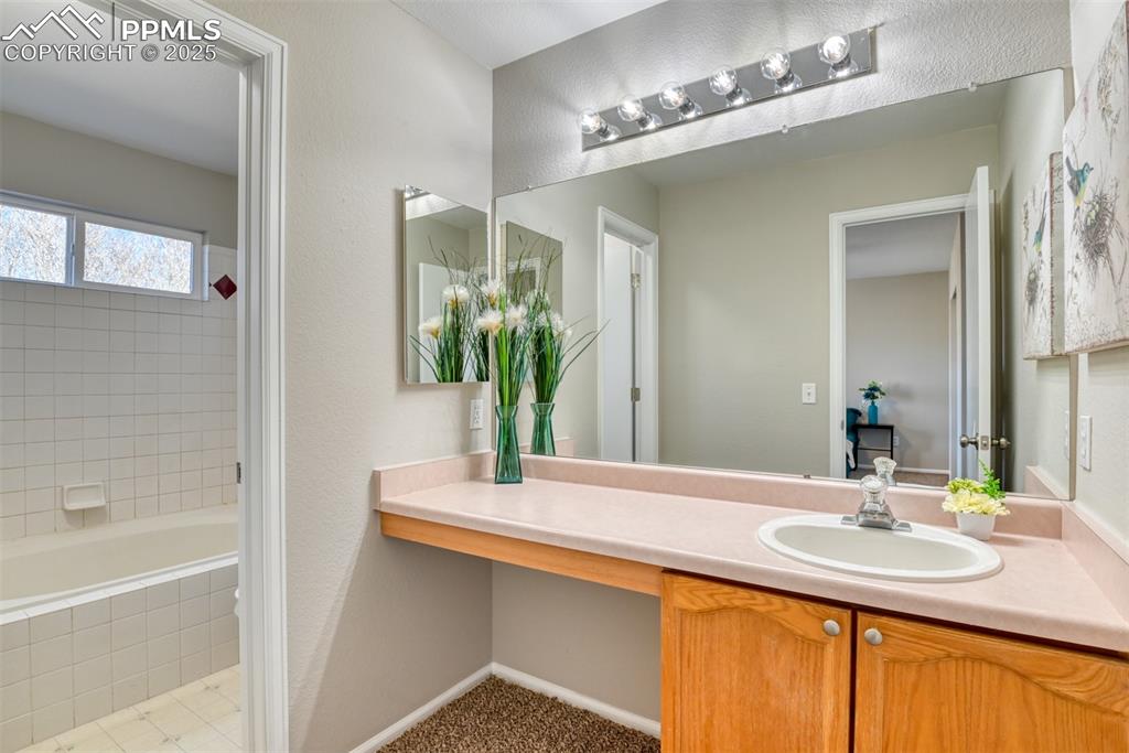 6810 Shore View Colorado Springs, CO 80922 - Photo 26 of 48 a bathroom with a sink and a mirror