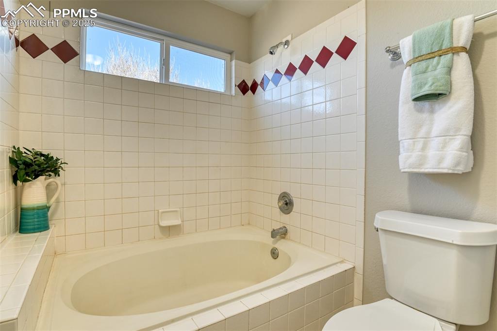 6810 Shore View Colorado Springs, CO 80922 - Photo 34 of 48 a white bath tub sitting next to a white toilet