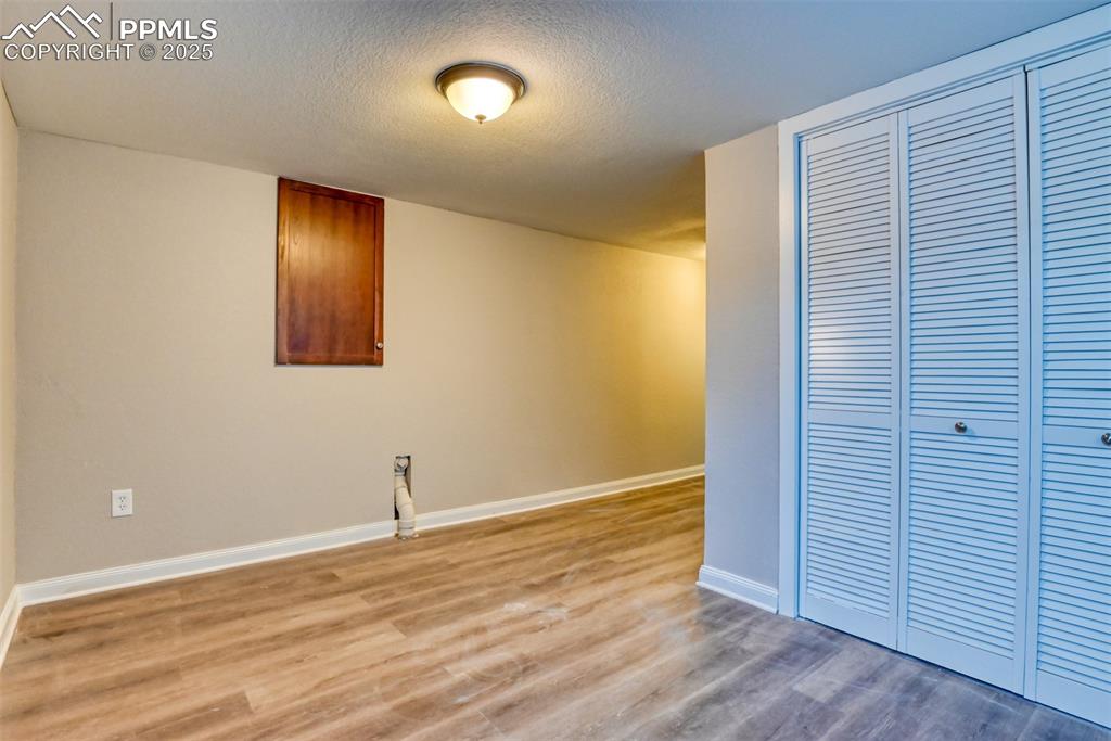6810 Shore View Colorado Springs, CO 80922 - Photo 44 of 48 an empty room with wooden floor and windows