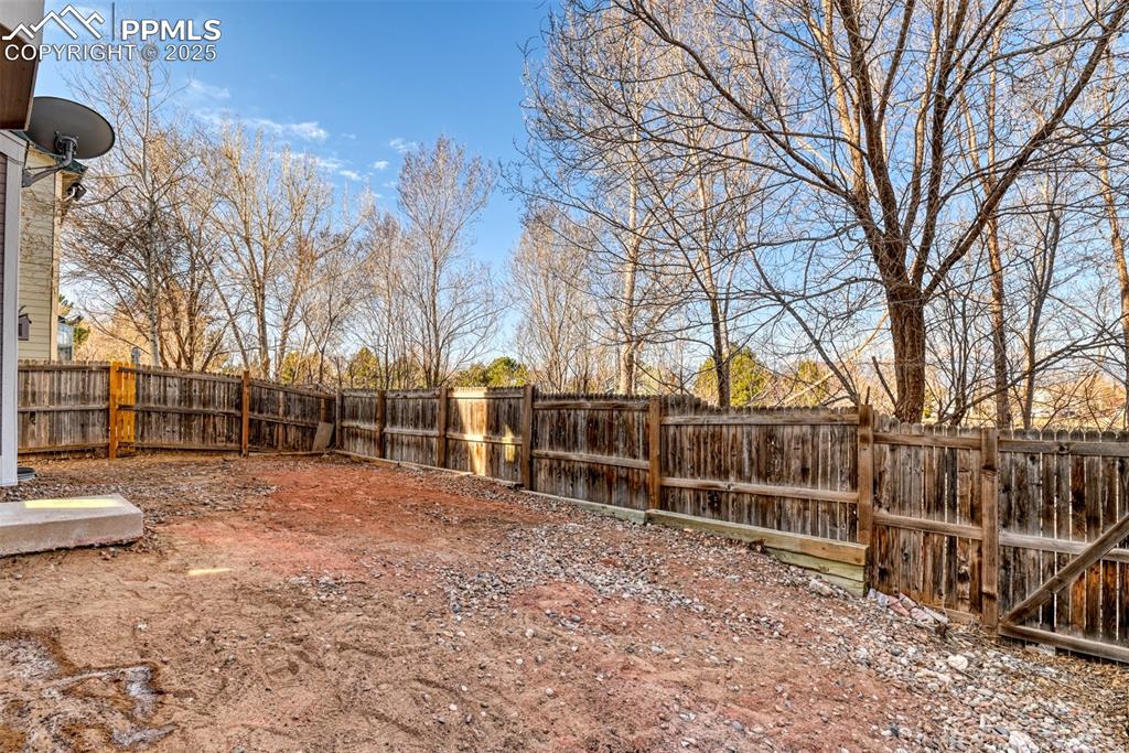 6810 Shore View Colorado Springs, CO 80922 - Photo 48 of 48 a view of a yard with wooden fence