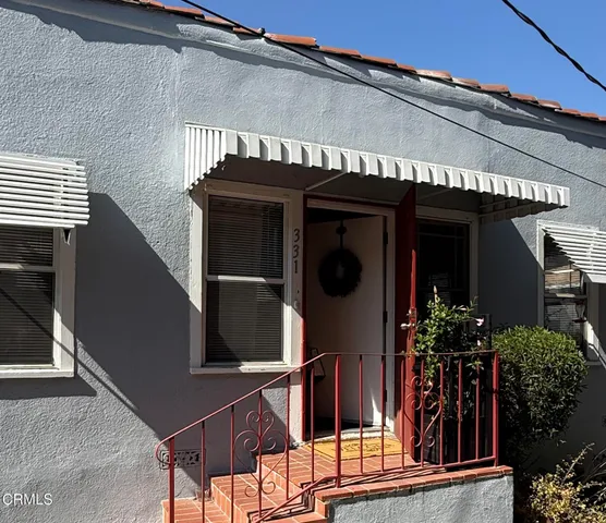 front view of a house with a potted plant