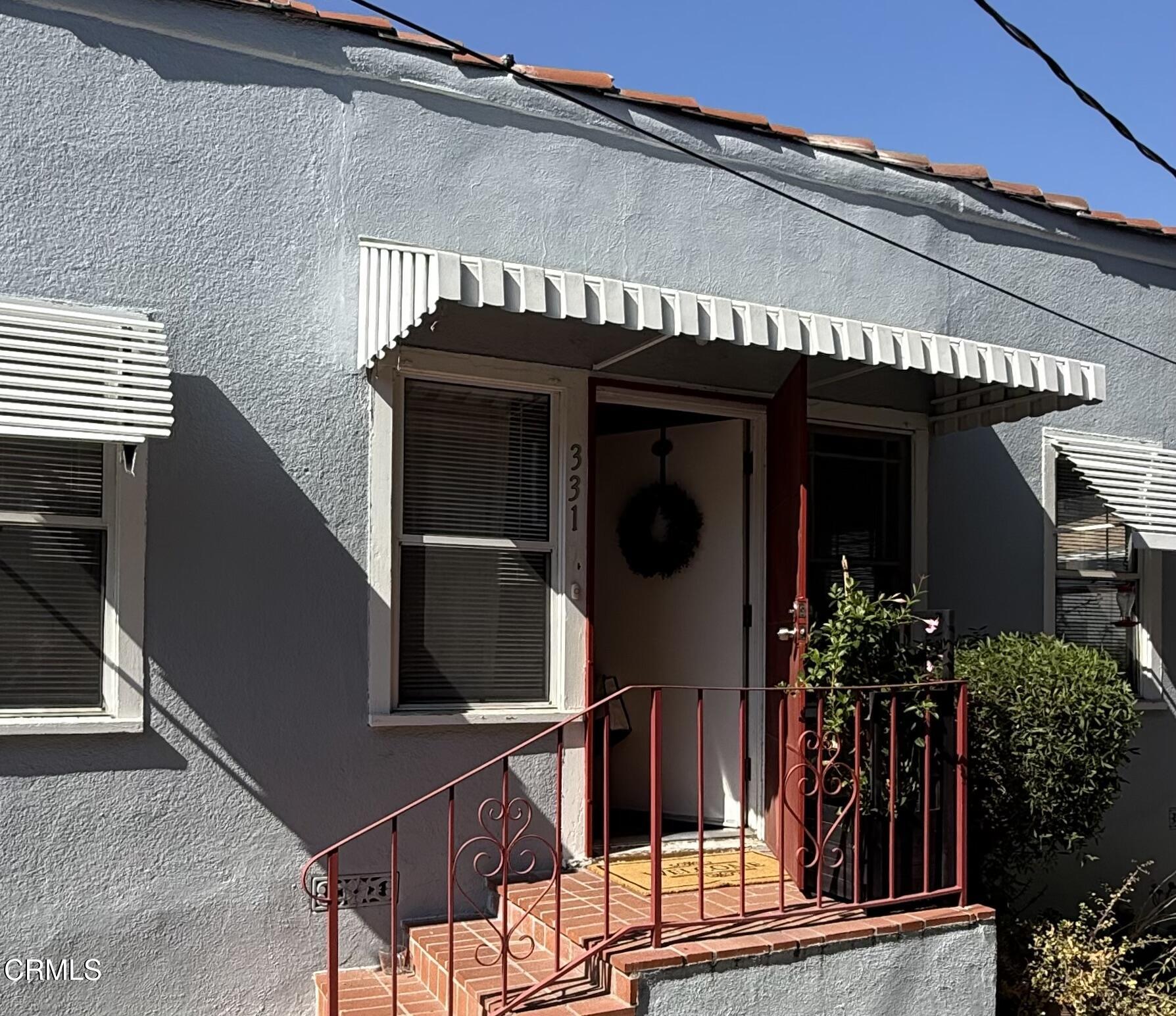 front view of a house with a potted plant