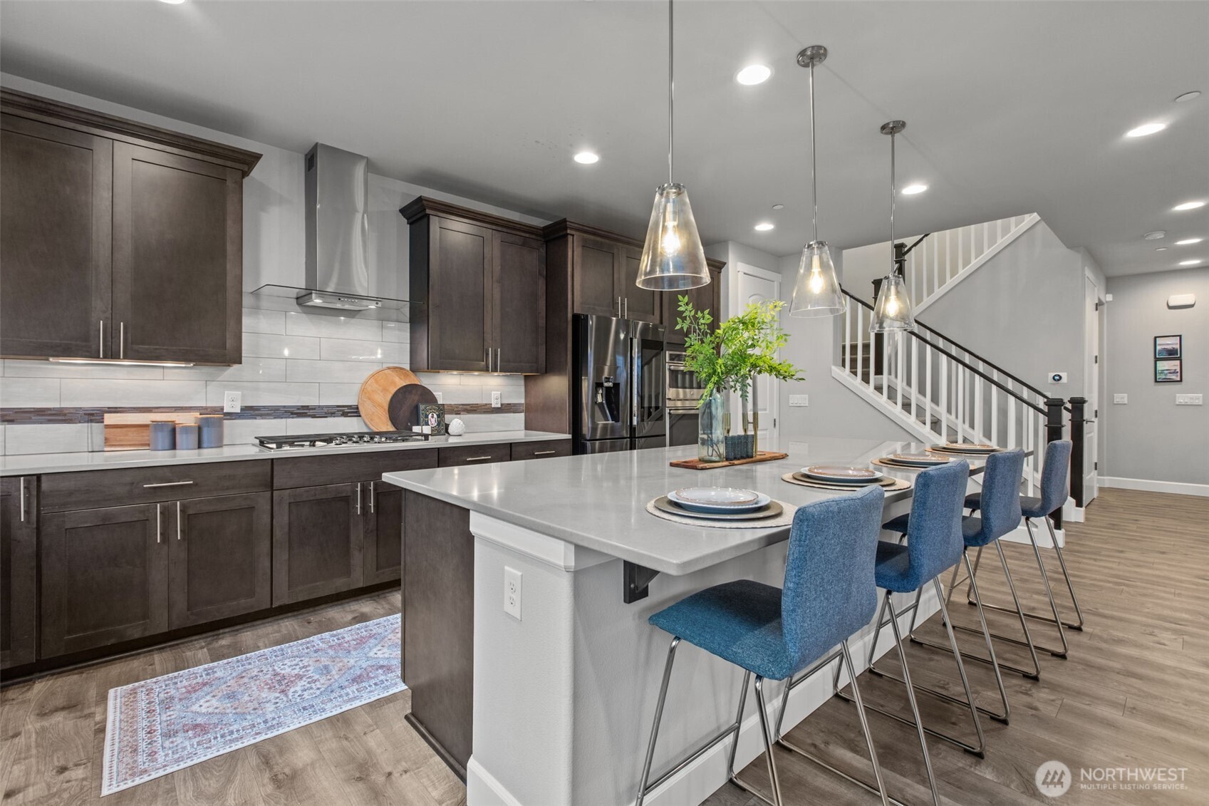 18231 3rd Drive Southeast Bothell, WA 98012 - Photo 8 of 40 a kitchen with stainless steel appliances kitchen island granite countertop a sink and cabinets