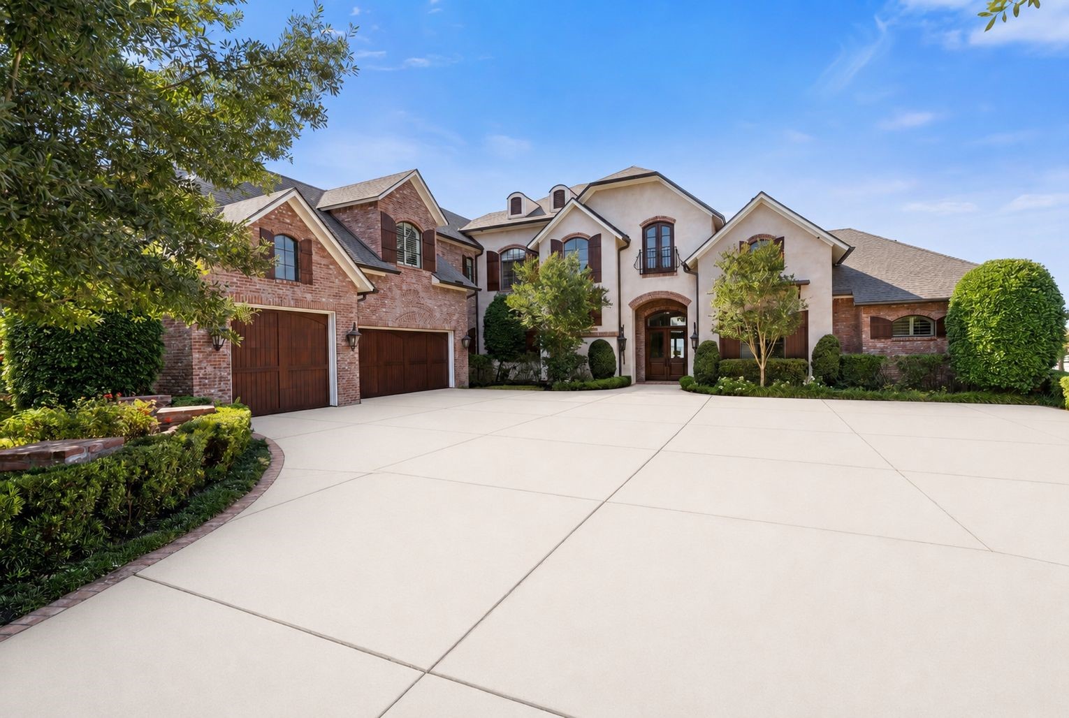 12349 Longmire Trace Conroe, TX 77304 - Photo 4 of 48 Grand brick-and-stucco facade, three-car garage, and a sweeping driveway made for arrivals.