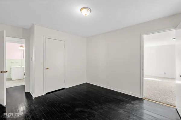 a view of an empty room and wooden floor