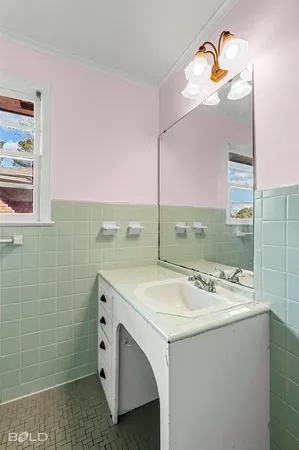 a bathroom with a sink vanity and mirror