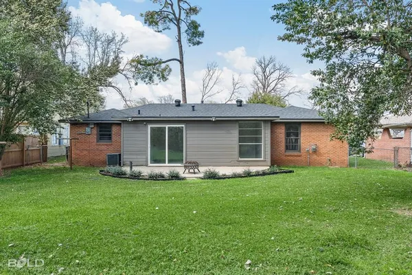 a view of a house with a yard and sitting area