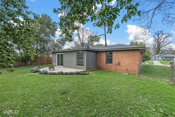 a view of a house with a yard and sitting area