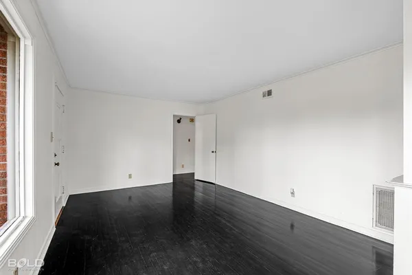 an empty room with wooden floor