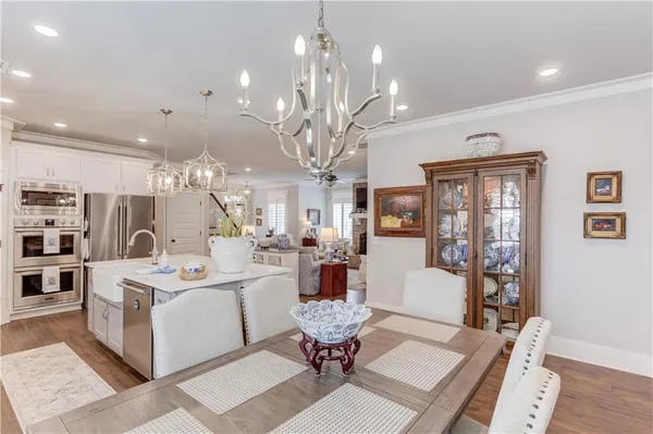 a living room with fireplace furniture and a chandelier