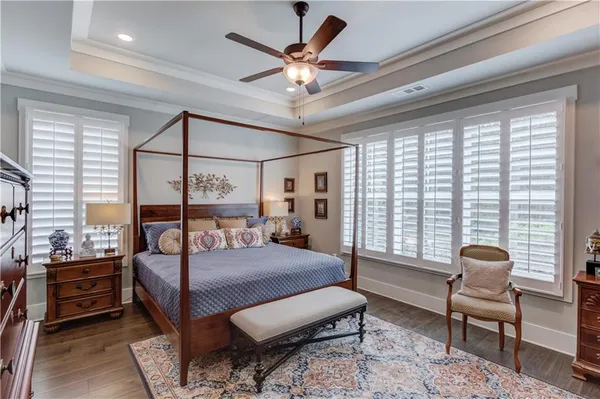 a bedroom with furniture and a large window
