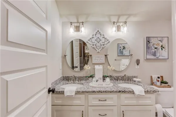 a bathroom with a granite countertop sink mirror and vanity