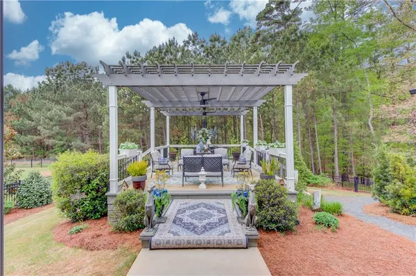 a view of a patio with table and chairs potted plants with wooden floor