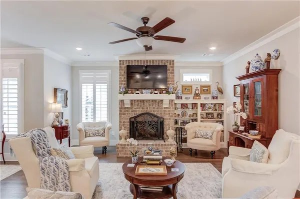 a living room with furniture a fireplace and a flat screen tv