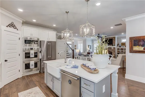 a kitchen with stainless steel appliances kitchen island granite countertop a sink and cabinets