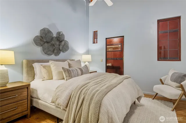 a bedroom with a bed and a painting on the wall