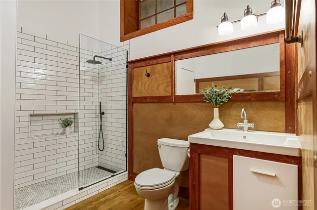 a bathroom with a toilet a sink and mirror