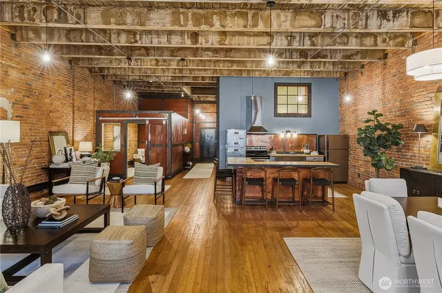 a living room with lots of furniture and a wooden floor